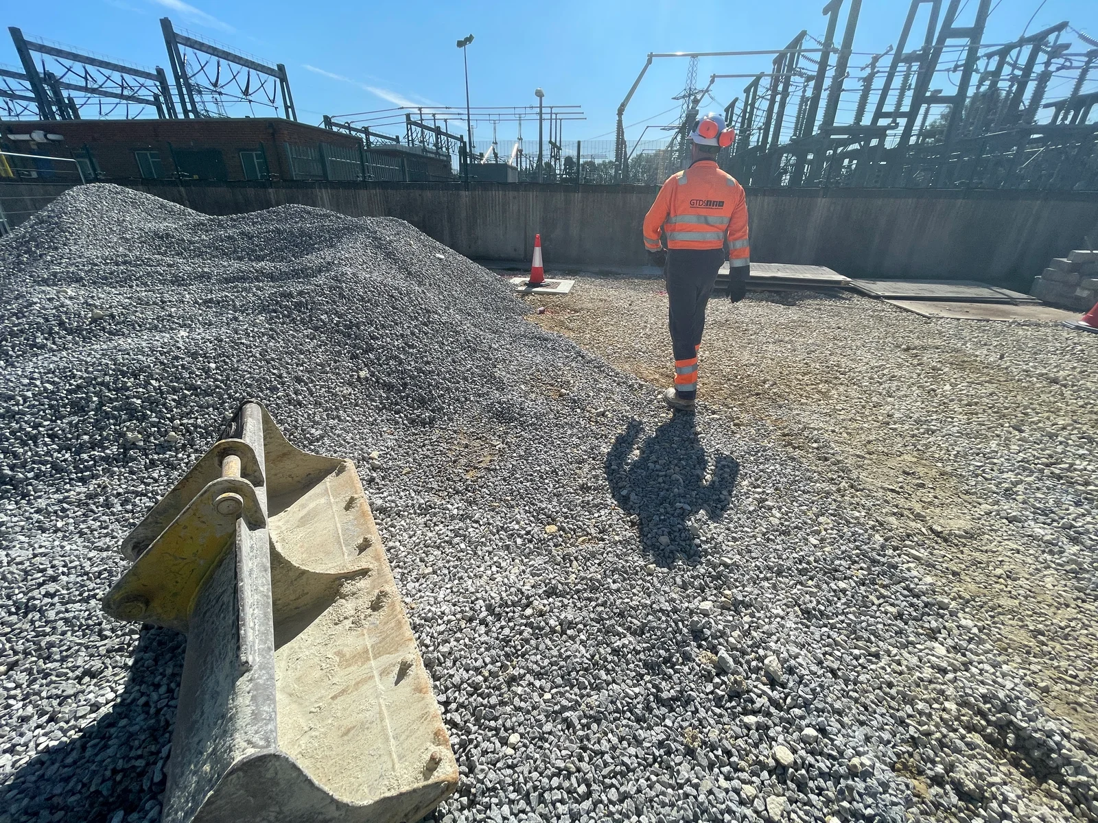 Drainage consultant reviewing a site plan and flood map alongside topographic survey drawings
